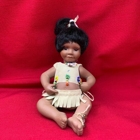 Geppeddo Porcelain Native American Baby Doll with Faux Deerskin Clothes - Picture 1 of 9